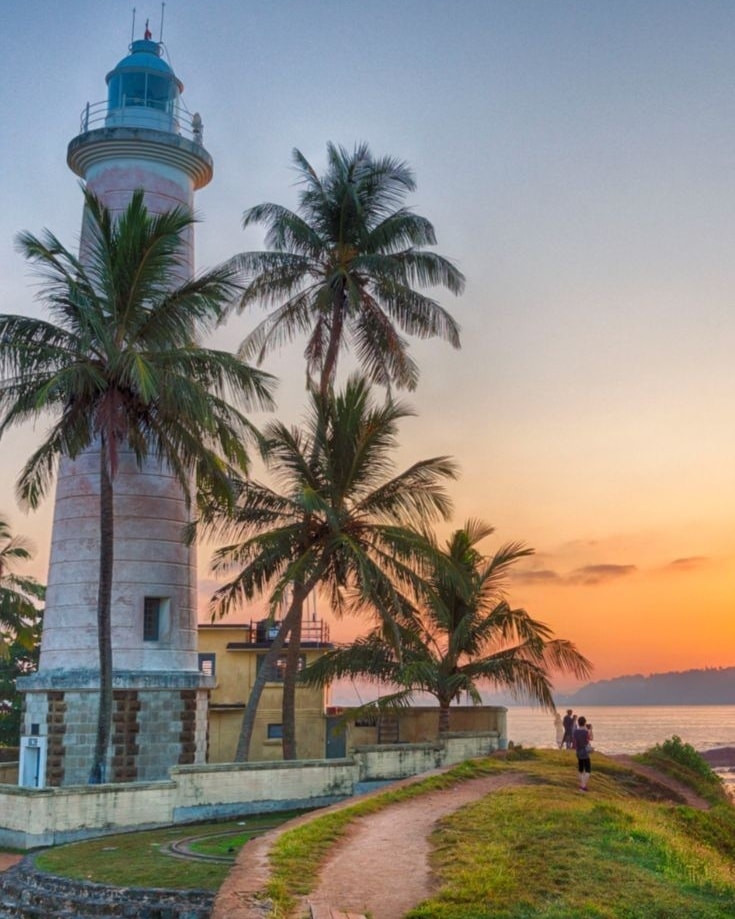 White lighthouse with sunset